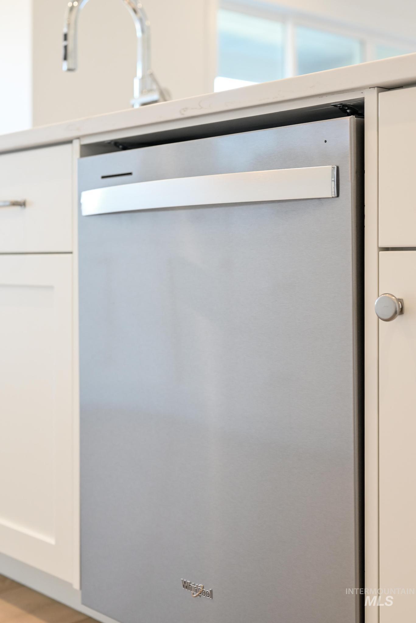 9800 West Novato Street Star, ID 83669 - Photo 14 of 40 Kitchen view of stainless steel dishwasher, white cabinets, and light countertops