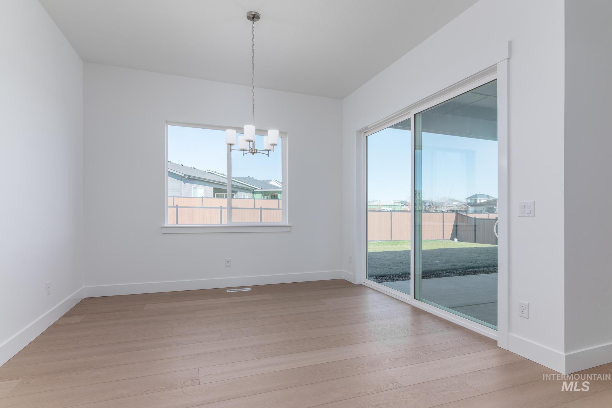 9800 West Novato Street Star, ID 83669 - Photo 17 of 40 Unfurnished dining area featuring suspended lighting and light wood-type flooring