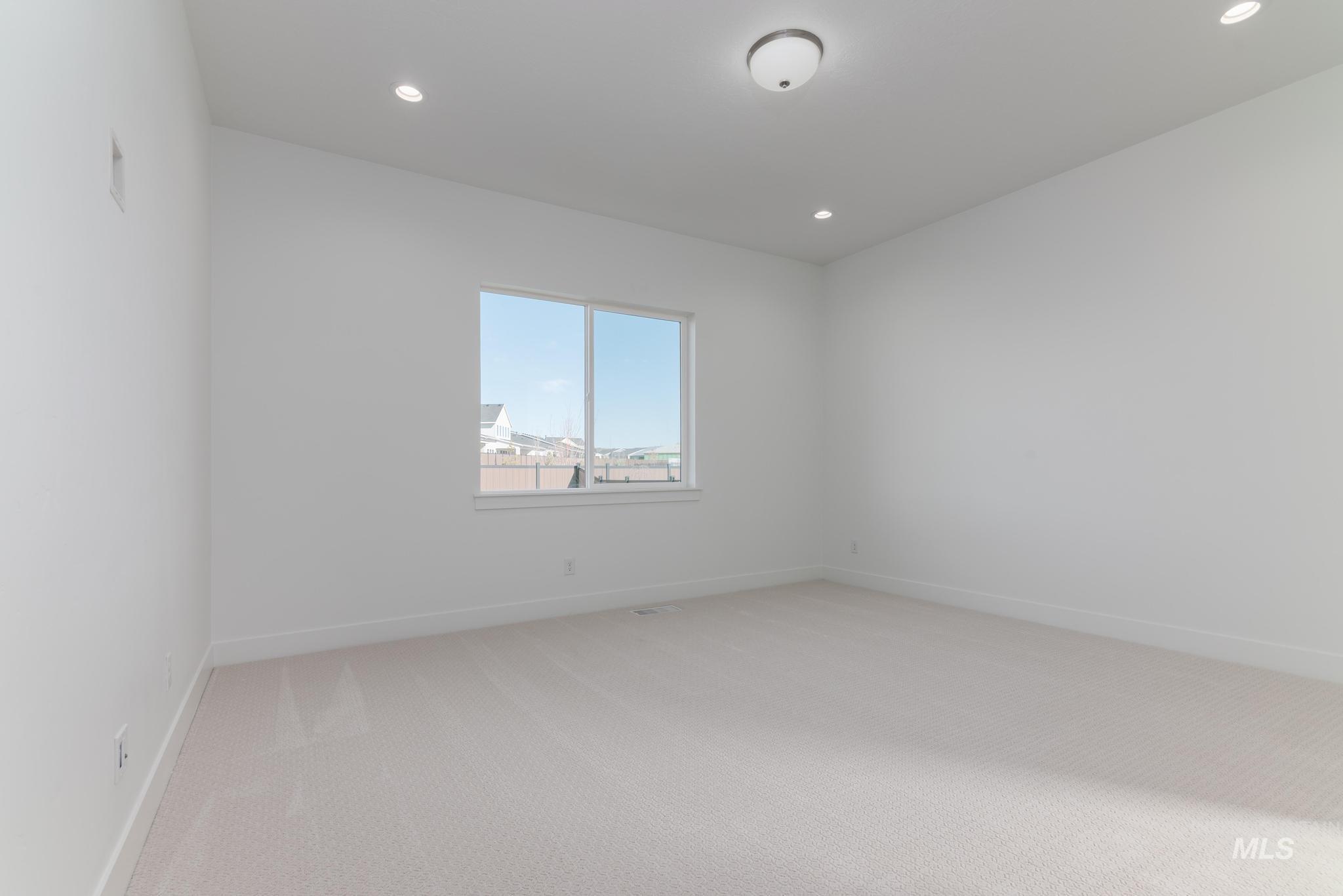 9800 West Novato Street Star, ID 83669 - Photo 19 of 40 Spare room with light colored carpet and recessed lighting