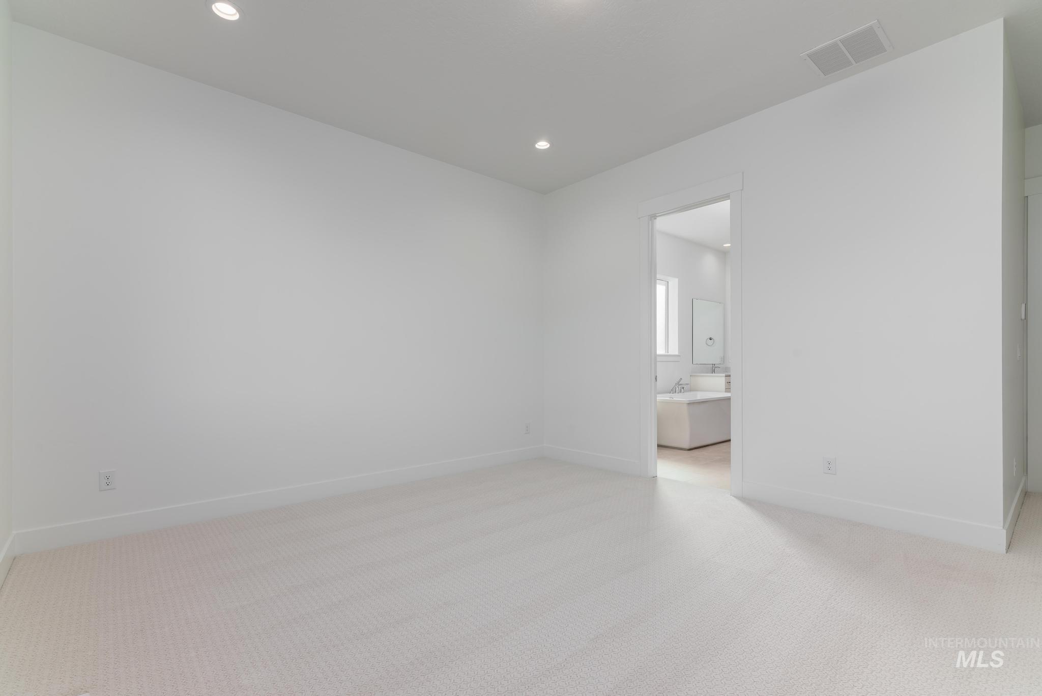 9800 West Novato Street Star, ID 83669 - Photo 20 of 40 Empty room with light carpet and recessed lighting