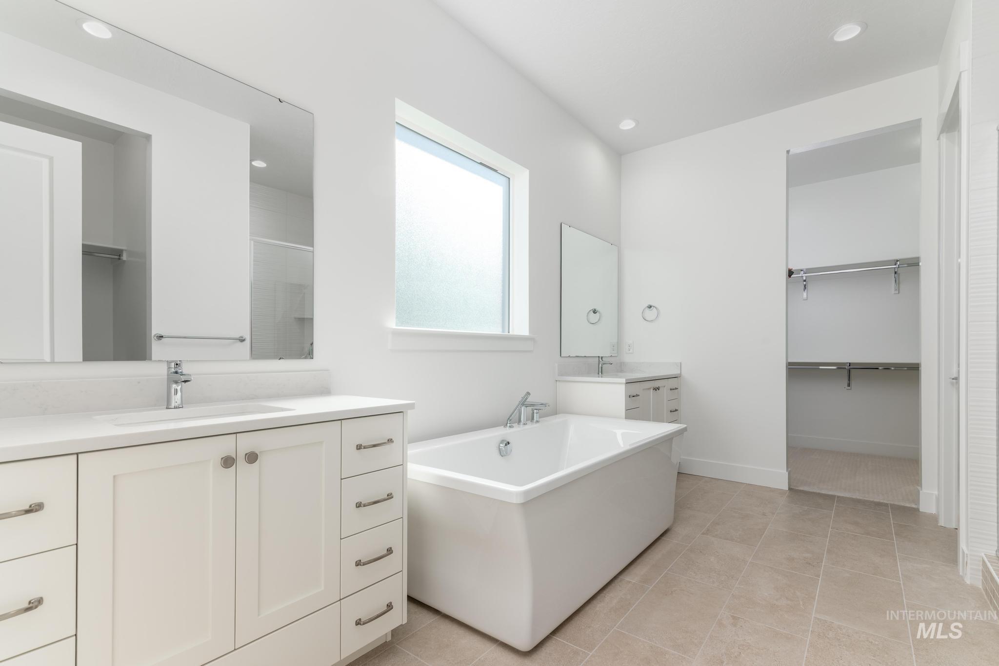 9800 West Novato Street Star, ID 83669 - Photo 21 of 40 Bathroom with a spacious closet, two vanities, recessed lighting, a freestanding tub, and a stall shower