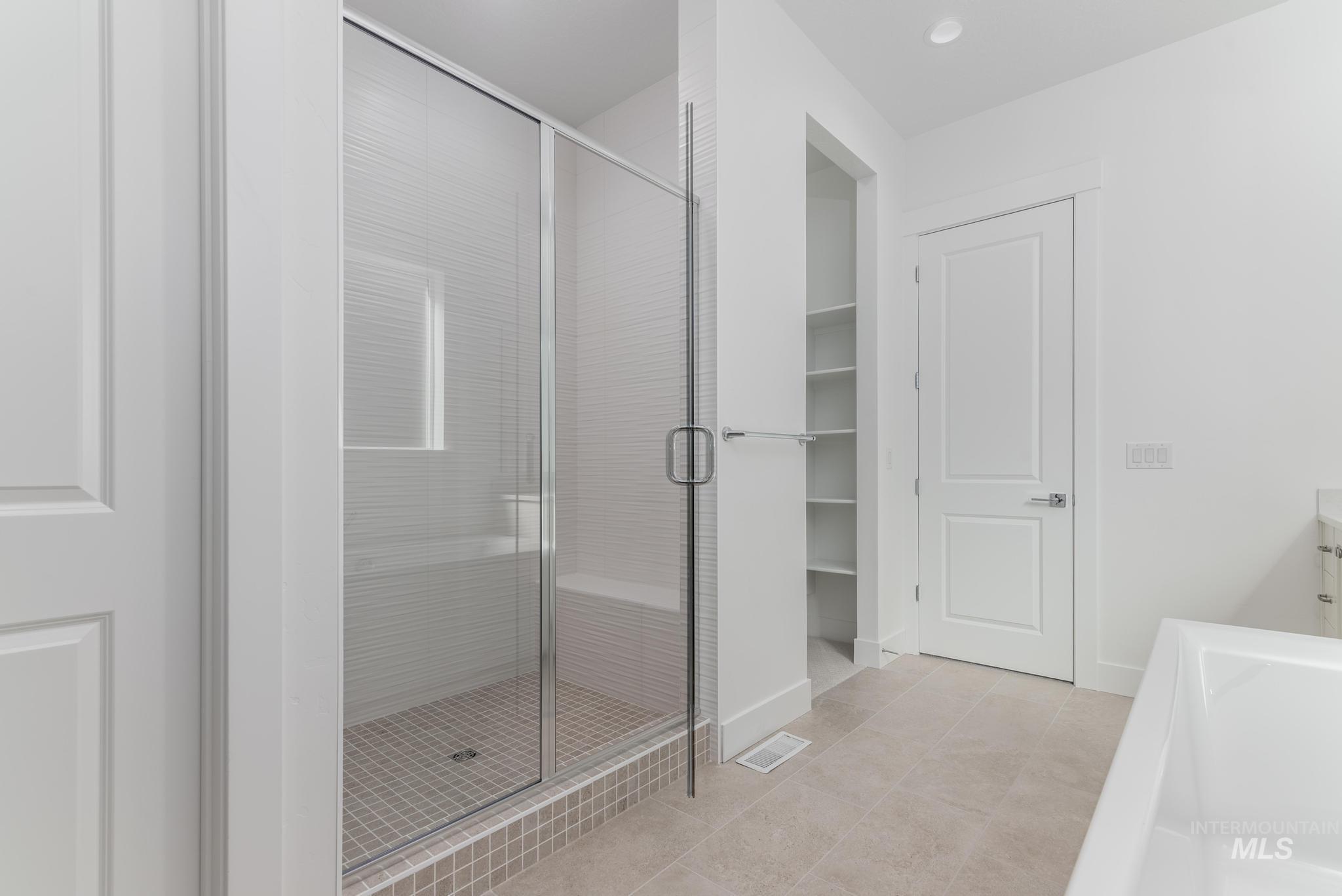 9800 West Novato Street Star, ID 83669 - Photo 22 of 40 Full bath featuring a stall shower, vanity, light tile patterned floors, and recessed lighting