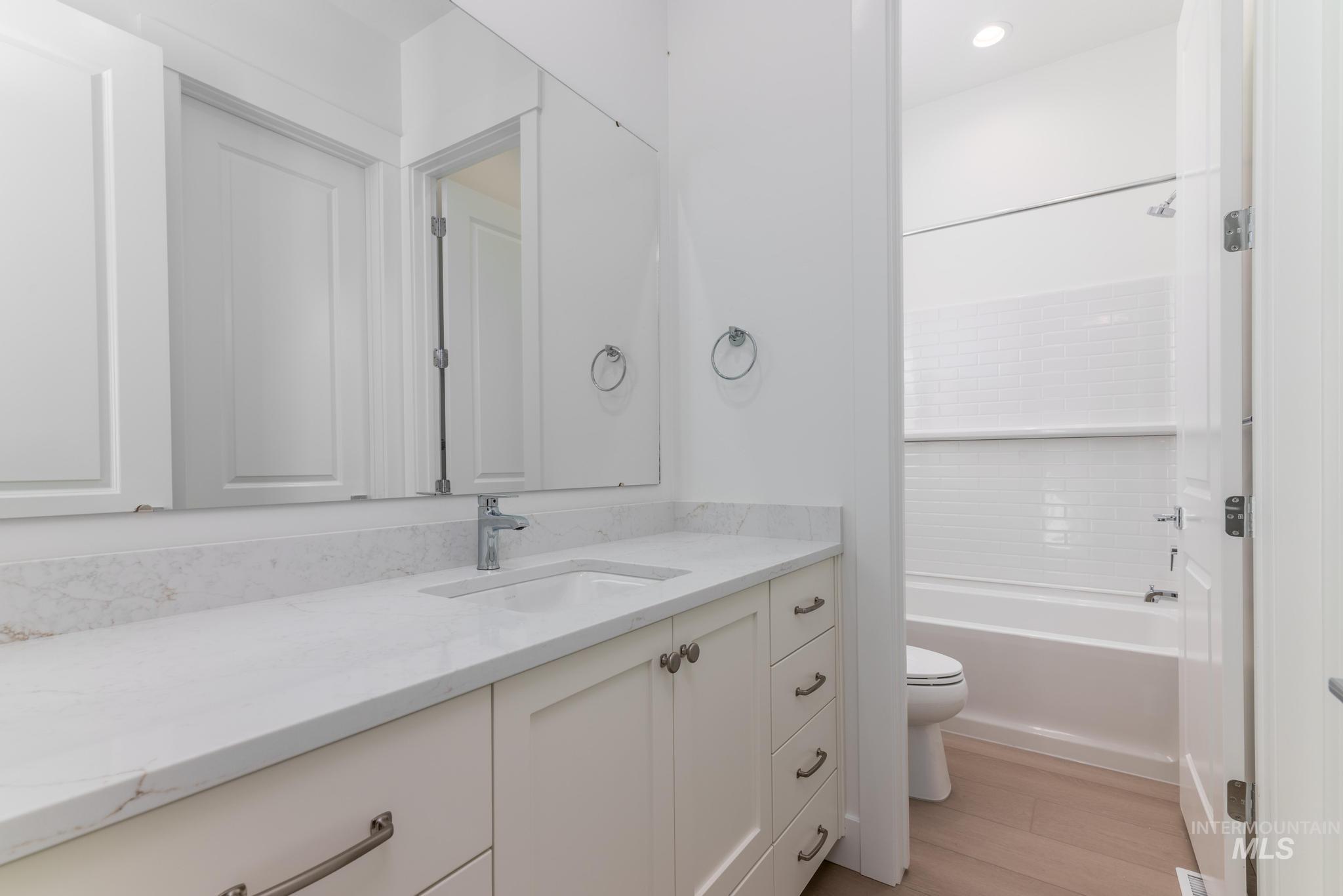 9800 West Novato Street Star, ID 83669 - Photo 25 of 40 Bathroom with vanity, shower / tub combination, and light wood-style flooring