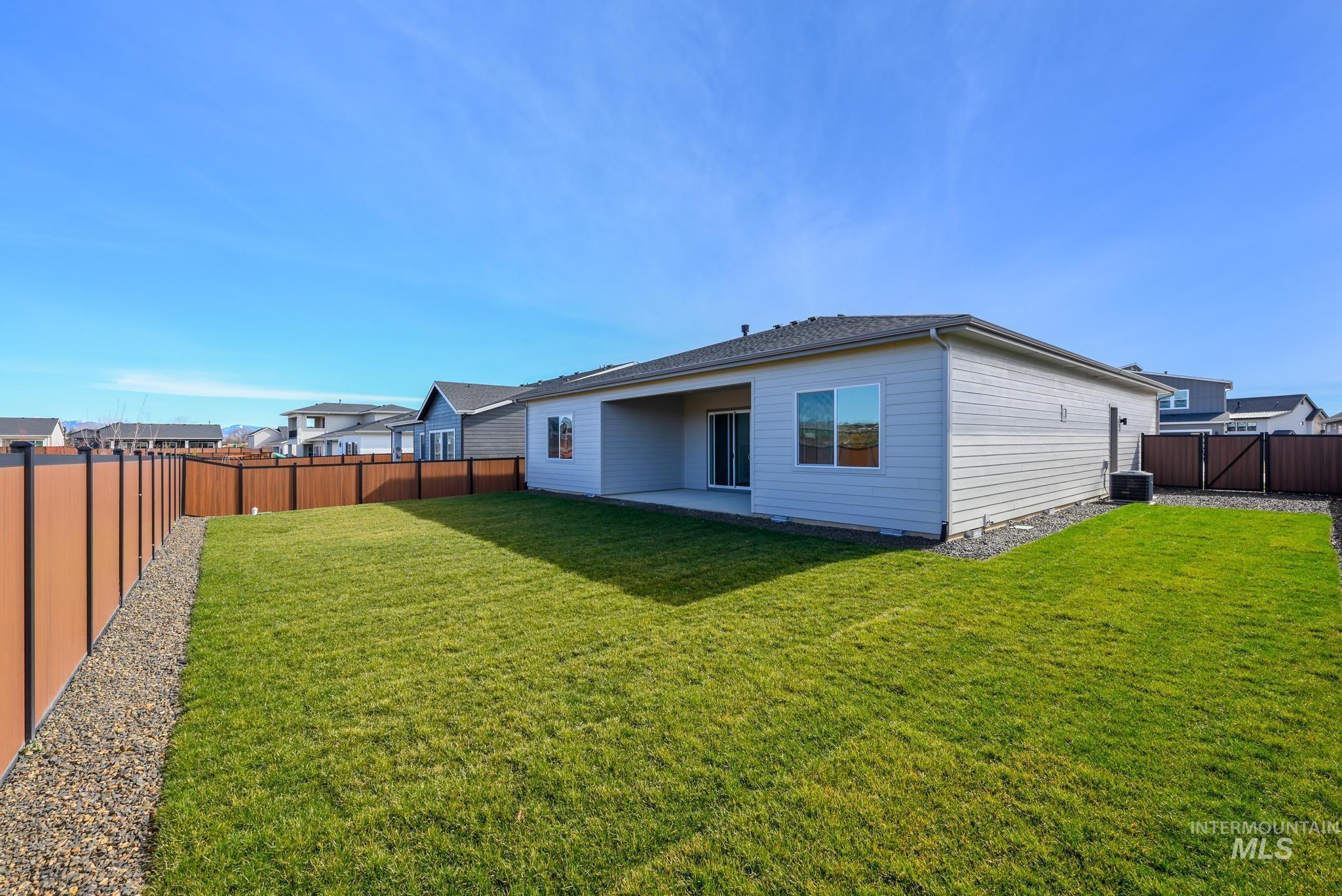 9800 West Novato Street Star, ID 83669 - Photo 27 of 40 Rear view of house featuring a patio, a fenced backyard, and a gate
