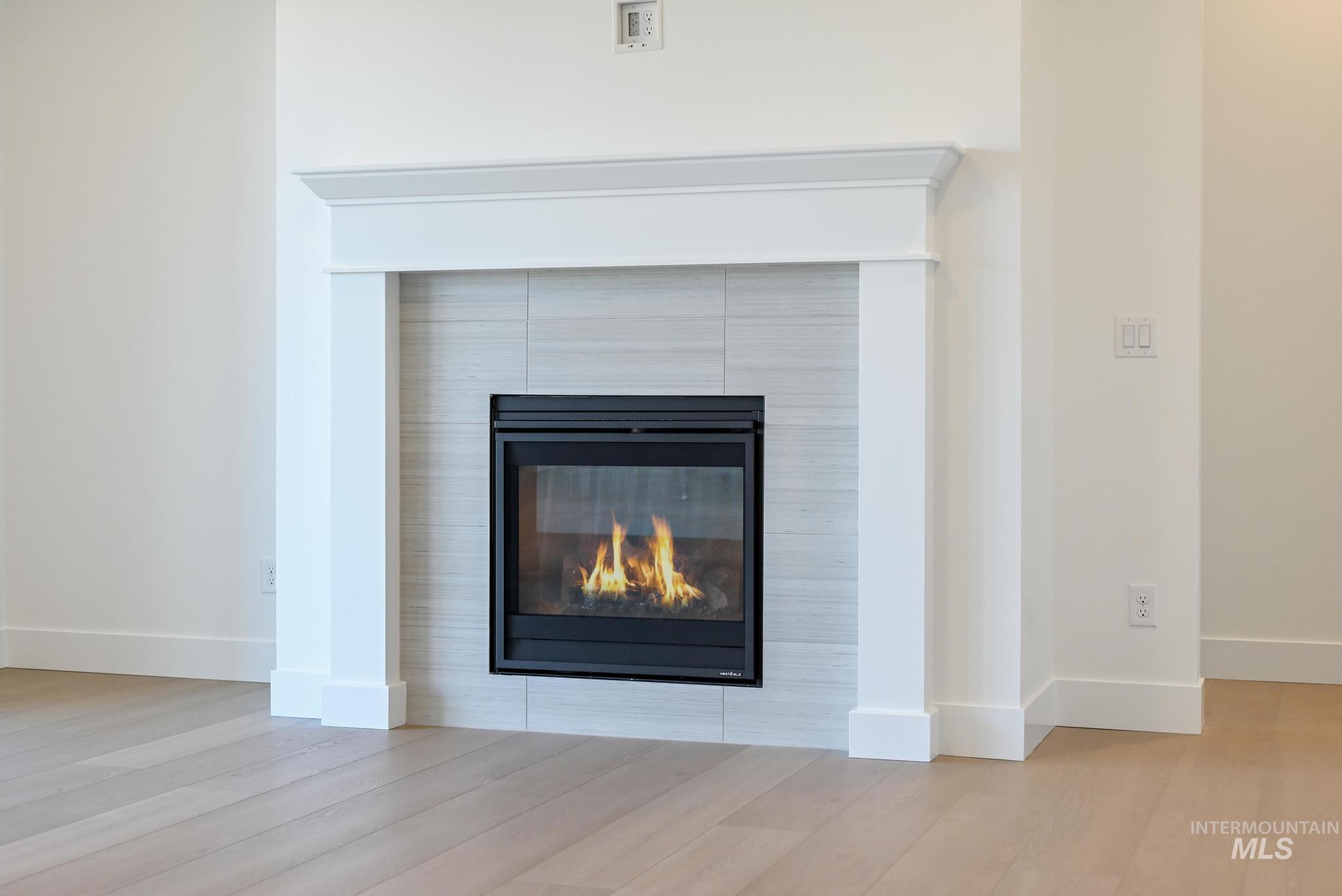 9800 West Novato Street Star, ID 83669 - Photo 6 of 40 Detailed view of a tiled fireplace and wood finished floors