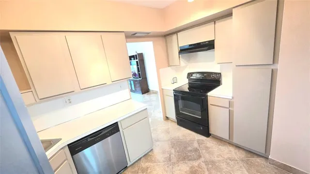 a kitchen with a refrigerator and a stove
