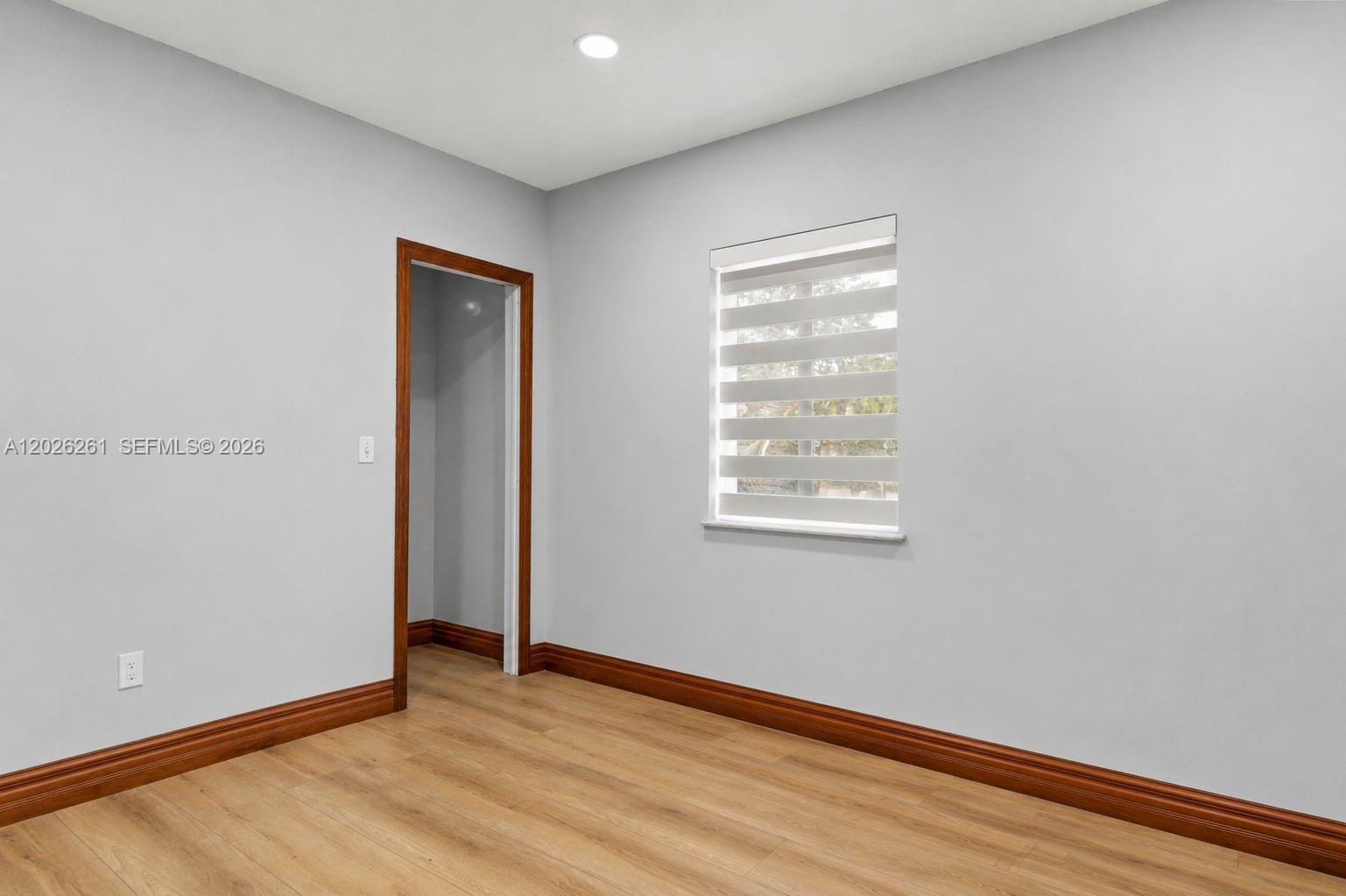 6250 Southwest 20th Terrace Miami, FL 33155 - Photo 18 of 42 an empty room with wooden floor and windows