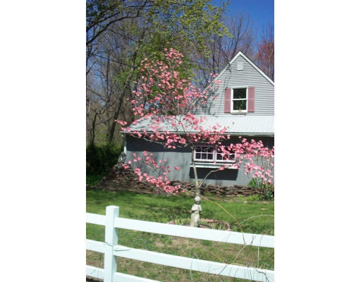 1976 Wilbraham Road Springfield, MA 01129 - Photo 5 of 12 a view of a wooden house with a yard and large trees