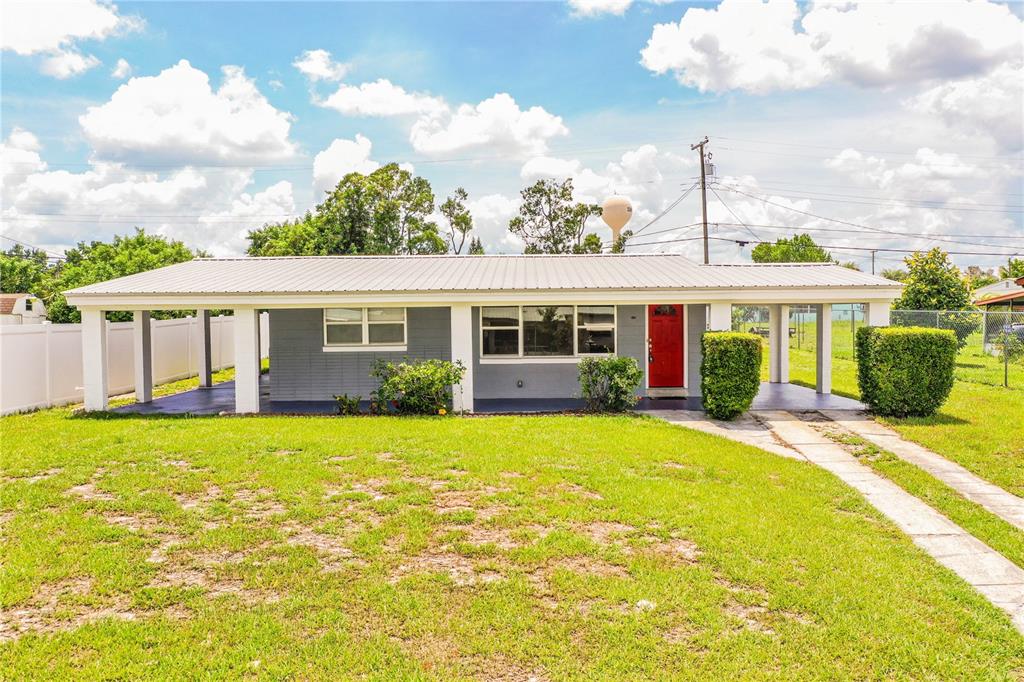 312 Thomas Avenue Frostproof, FL 33843 - Photo 1 of 1 a front view of a house with a garden