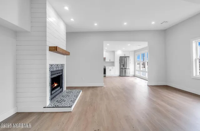 a view of an empty room and a fireplace