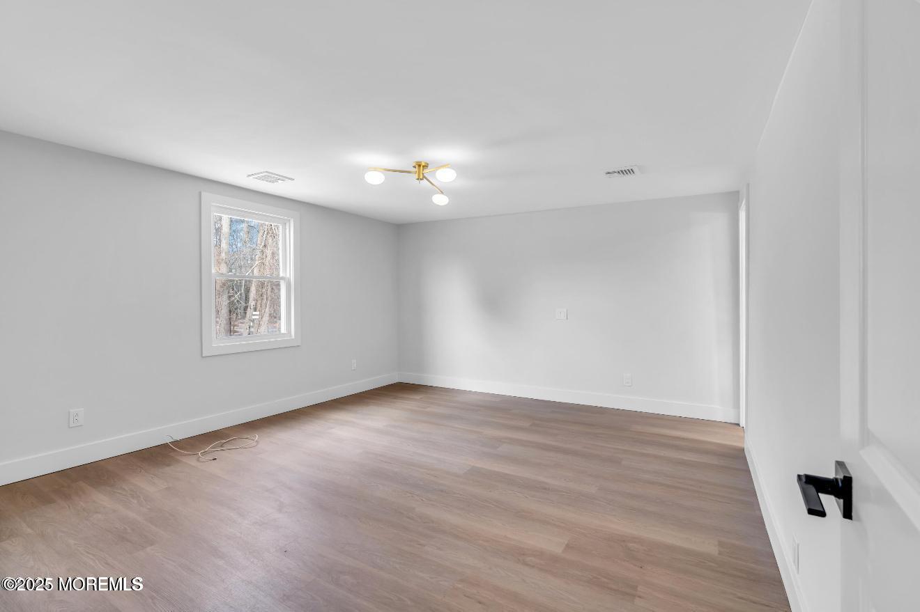 23 A Stoney Hill Road Cream Ridge, NJ 08514 - Photo 20 of 46 a view of an empty room with wooden floor and a window