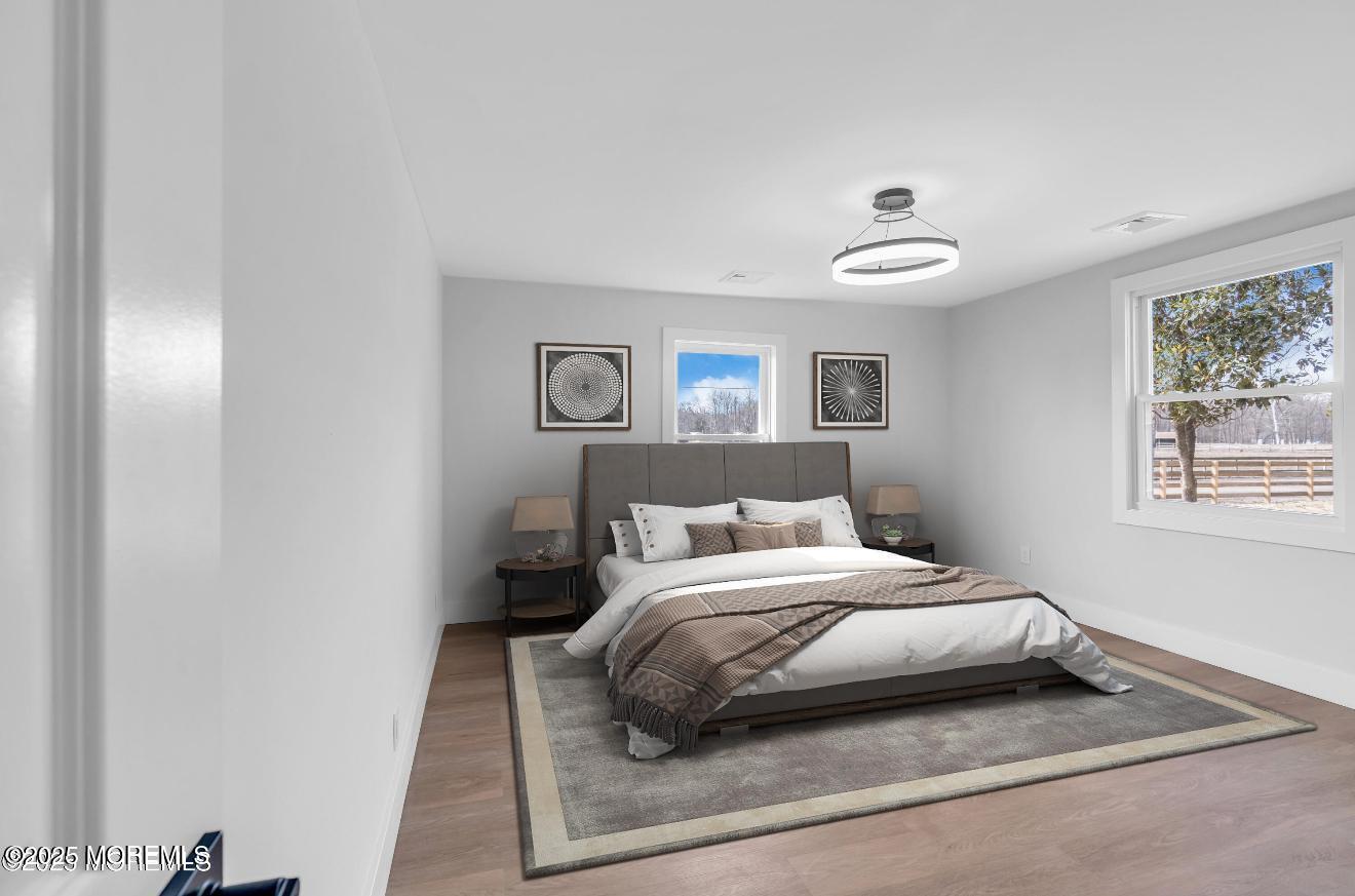 23 A Stoney Hill Road Cream Ridge, NJ 08514 - Photo 23 of 46 a bedroom with a bed and a painting on the wall