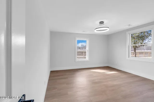 wooden floor in an empty room with a window