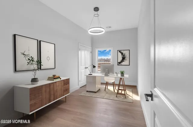 a view of a dining room with furniture and chandelier
