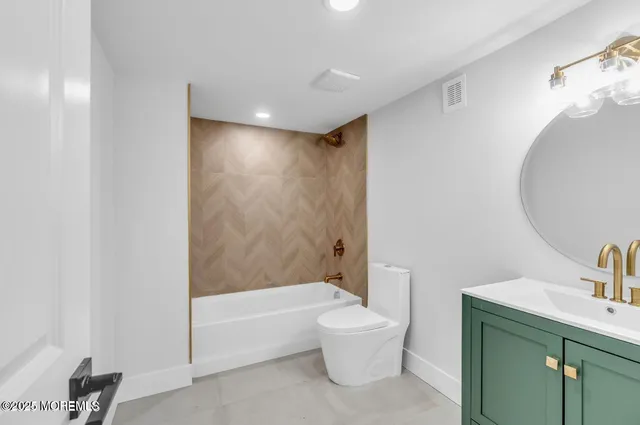 a bathroom with a toilet a sink and bathtub