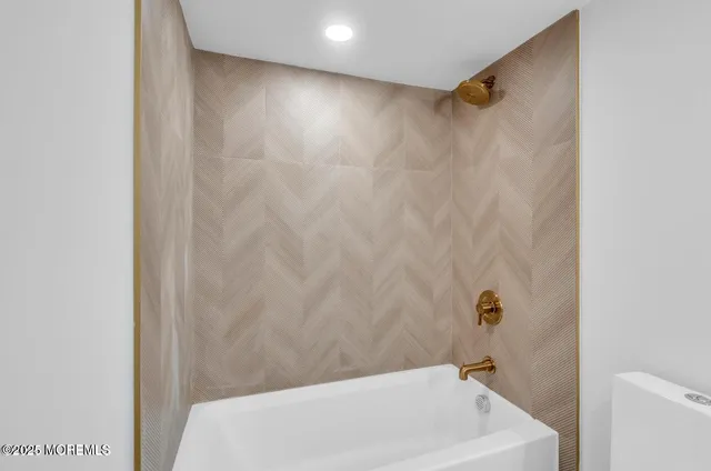 a bathroom with a white bath tub and a shower curtain