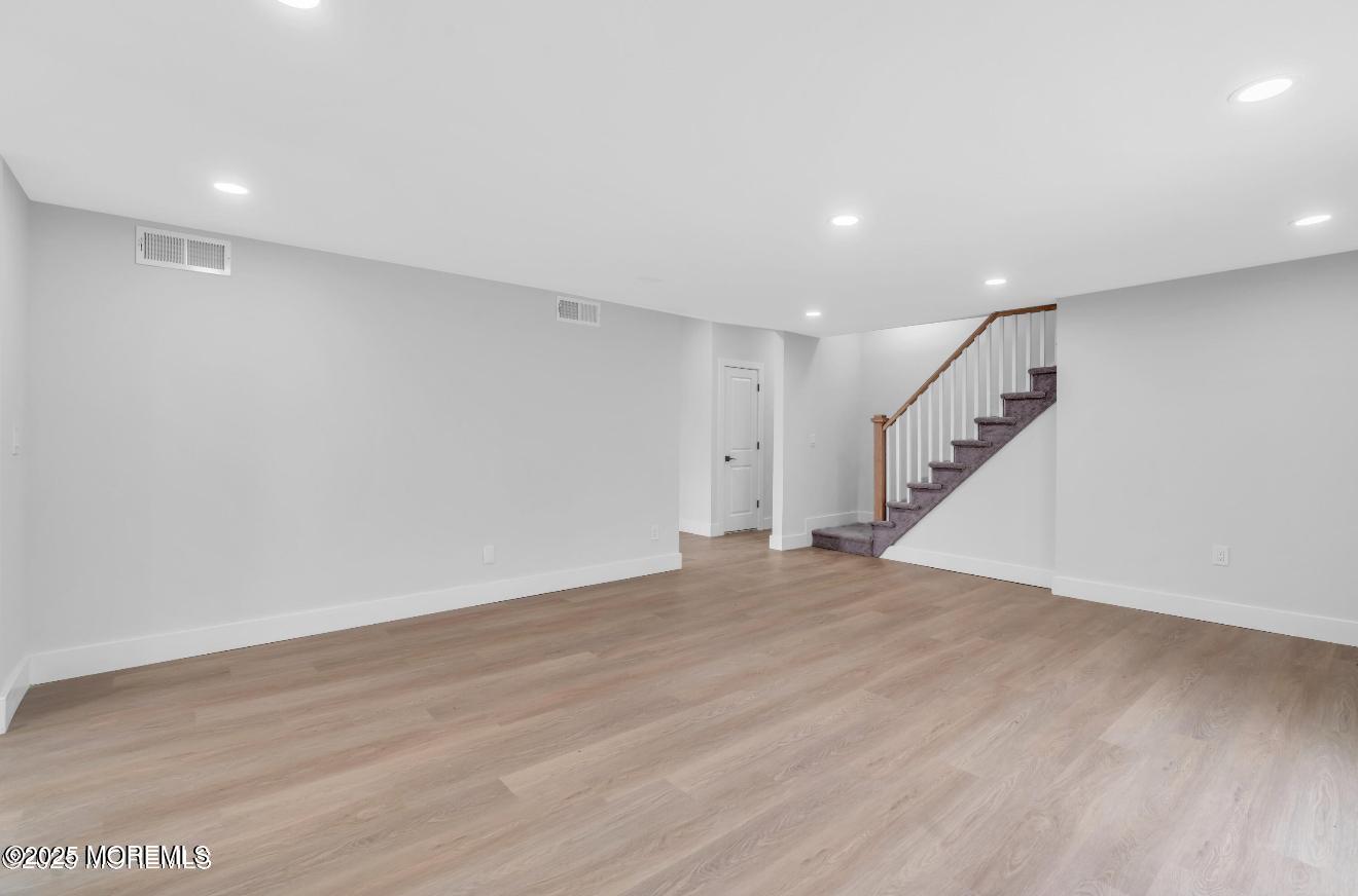 23 A Stoney Hill Road Cream Ridge, NJ 08514 - Photo 31 of 46 an empty room with wooden floor and staircase
