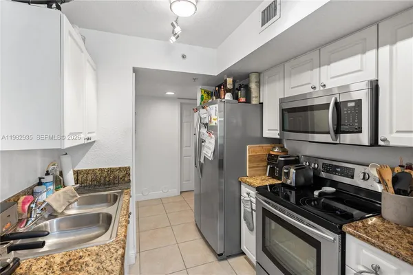 a kitchen with a stove a microwave and refrigerator