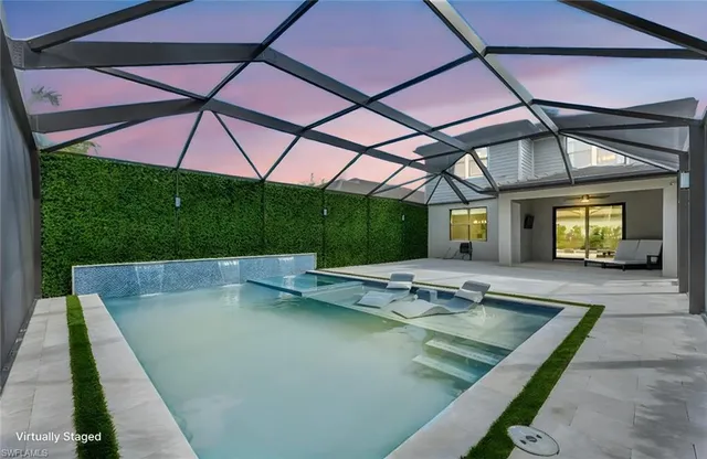swimming pool view with a seating space