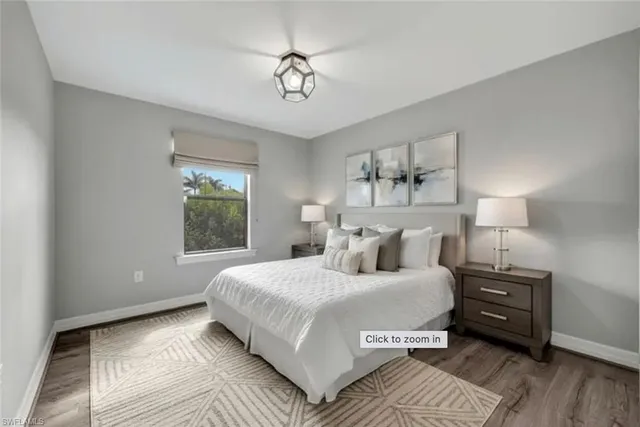 a bedroom with a large bed and a window