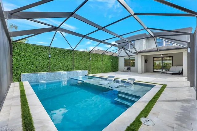 an outdoor space with swimming pool and furniture