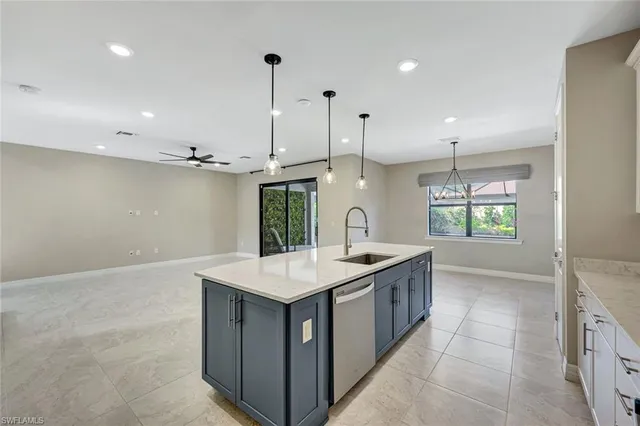 a kitchen with a sink window and wooden floor