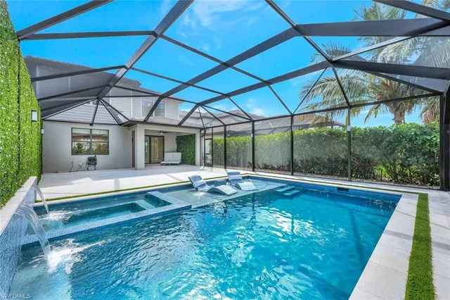 a view of a backyard with table and chairs under an umbrella