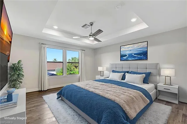 a bedroom with a large bed and a chandelier