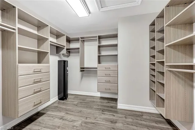 a view of walk in closet with clothes and shoes