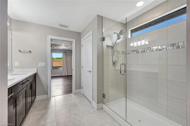 a spacious bathroom with a shower and a sink