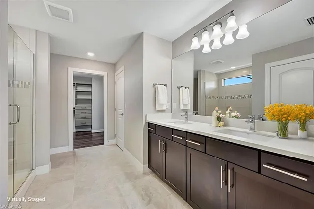 a bathroom with a sink double vanity and a mirror