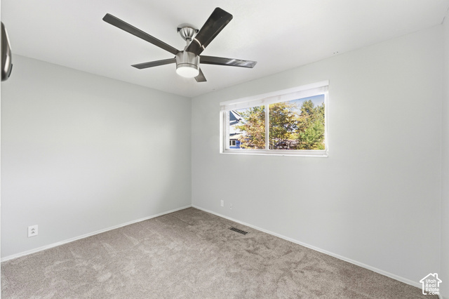 8746 Gladiator Way Sandy, UT 84094 - Photo 18 of 36 Recessed window with white trim, a modern ceiling fan, wall-to-wall carpeting, and light-toned walls