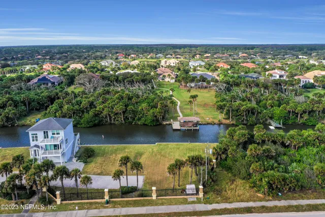 an aerial view of ocean with residential houses with outdoor space and seating