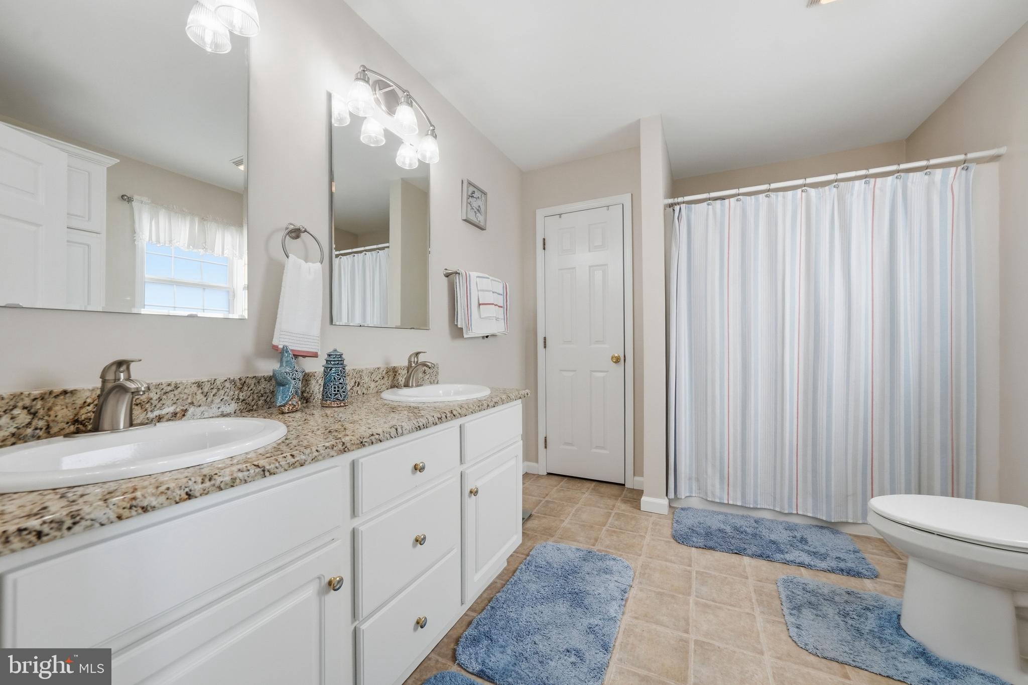 430 Rt Us 9 Street South, Unit 137 Marmora, NJ 08223 - Photo 16 of 24 a spacious bathroom with a granite countertop sink and a mirror