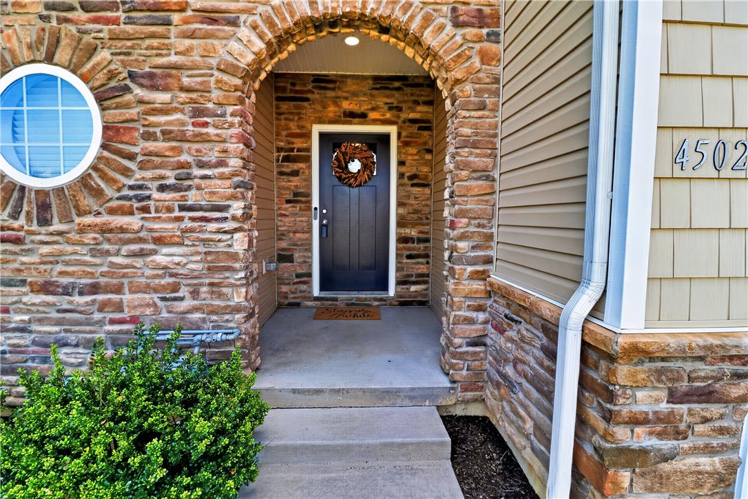 4502 Benjamin Court Emmaus, PA 18049 - Photo 3 of 48 A welcoming arched entryway and round window punctuate the textured stone and siding facade.