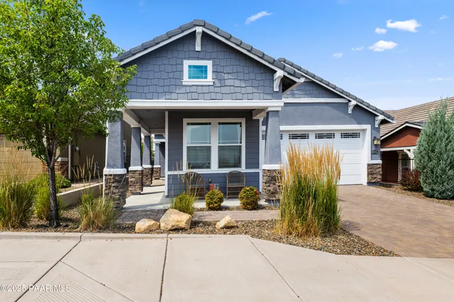 a front view of a house with sitting area
