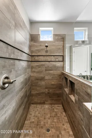 a view of walk in closet with clothes