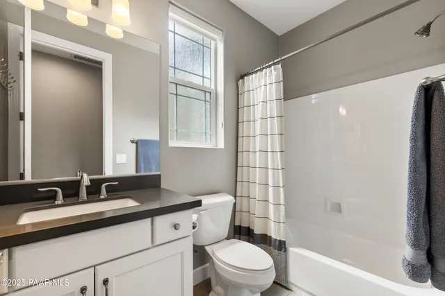 a bedroom with bed and window