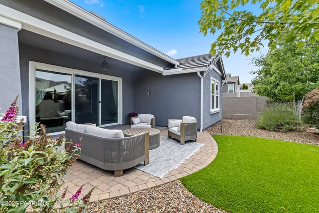 a view of an house with backyard sitting area and garden