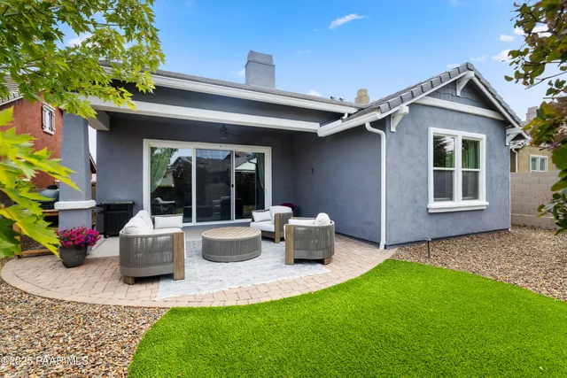 a view of a patio with table and chairs