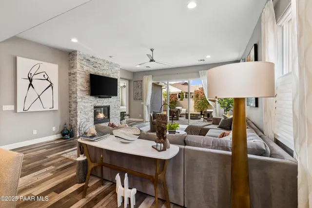 a living room with fireplace furniture and a flat screen tv