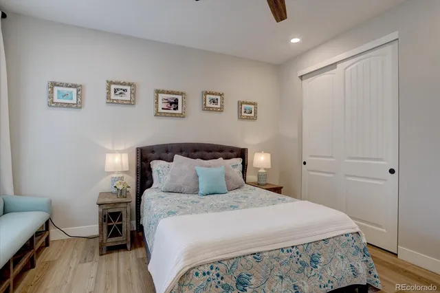 a bedroom with a bed and a wooden floor