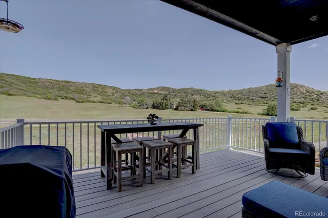 a view of a balcony with furniture and wooden floor