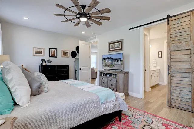 a bed room with a bed and a television