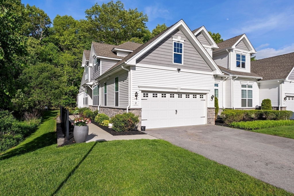 2 Hummingbird Way, Unit 1 Methuen, MA 01844 - Photo 2 of 42 a front view of a house with a garden and plants