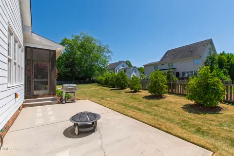 a view of a house with pool and a yard