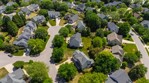 an aerial view of a house with outdoor space and sitting area