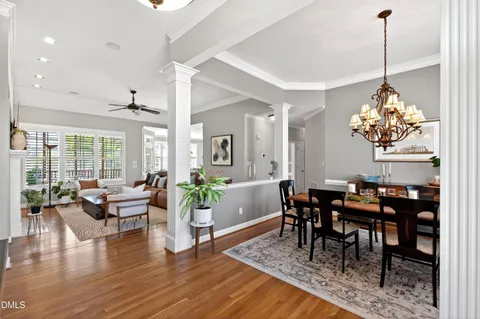 a view of a dining room with furniture wooden floor and chandelier