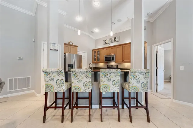 a dining room with furniture and kitchen view