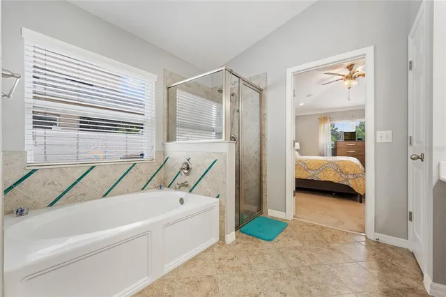 a en suite bathroom with a granite countertop tub and a sink